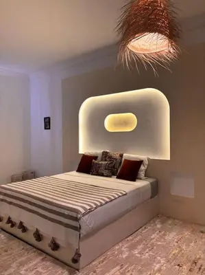 a bedroom with a bed with a raised head board at Loft Marrakech 5 min du centre super emplacement in Marrakech