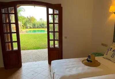 a bedroom with a bed and an open door at Villa Keshmere in Marrakech