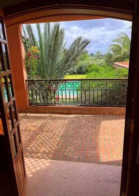 an open door to a balcony with a view of the ocean at Villa Keshmere in Marrakech