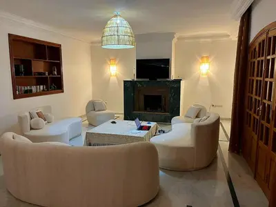 a living room with two couches and a fireplace at Villa Keshmere in Marrakech