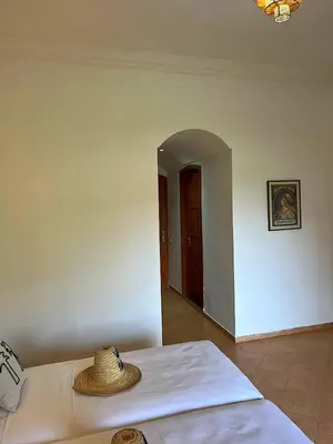 a room with a bed with a straw hat on it at Villa Keshmere in Marrakech