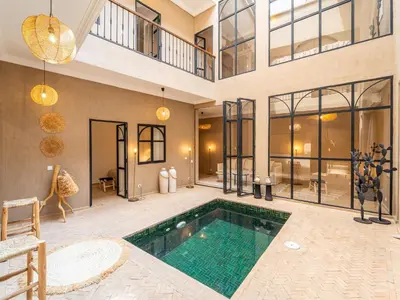 a large house with a swimming pool in a room at Serenity Riad with Breakfast in Marrakech