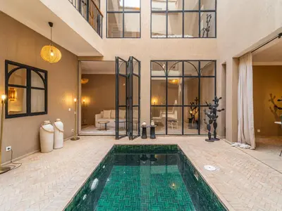 a house with a swimming pool in the middle of a house at Serenity Riad with Breakfast in Marrakech