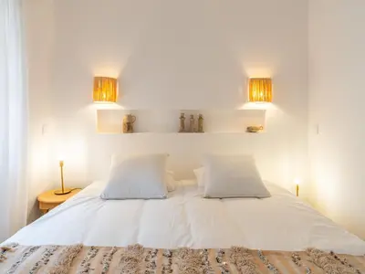 a bedroom with a white bed with two pillows at Serenity Riad with Breakfast in Marrakech