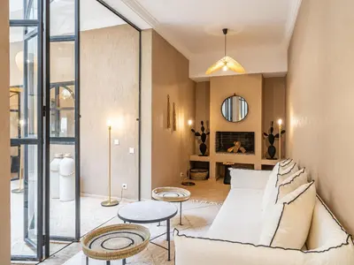 a living room with a couch and a table at Serenity Riad with Breakfast in Marrakech