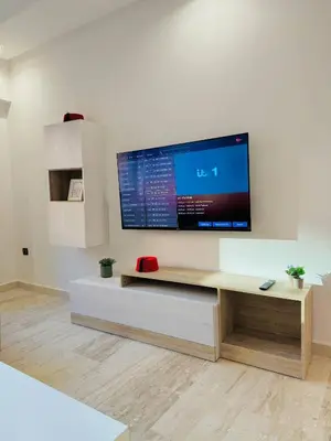 a living room with a flat screen tv on a wall at Le Gueliz Centeral cosy Suite in Marrakech