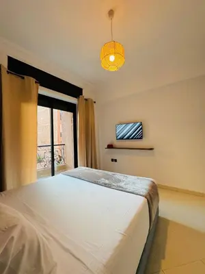 a bedroom with a large bed and a window at Le Gueliz Centeral cosy Suite in Marrakech