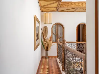 a hallway of a home with a staircase with a tile floor at Riad Nesayam - Riad Privatisé - 3 Suites - Piscine Chauffée in Marrakech