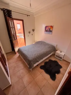 a bedroom with a bed and a window and a door at Superbe appartement au porte de gueliz in Marrakech