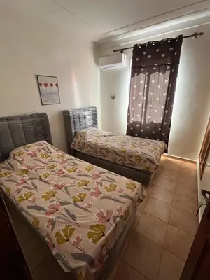 a bedroom with two beds in a room at Superbe appartement au porte de gueliz in Marrakech