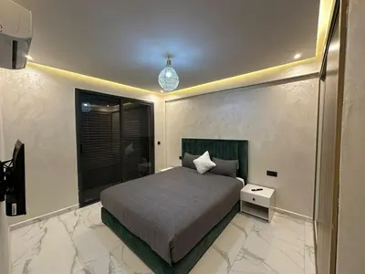a bedroom with a bed and a window at Résidence Joudad Guéliz in Marrakech