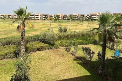 an aerial view of a park with palm trees at Appartement avec Piscine Prestigia Agate Marrakech in Marrakech