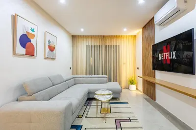 a living room with a couch and a table at RA 14 Calme et Cosy Netflix, Wifi et parking gratuits in Marrakech