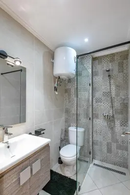 a bathroom with a toilet and a glass shower at RA 14 Calme et Cosy Netflix, Wifi et parking gratuits in Marrakech