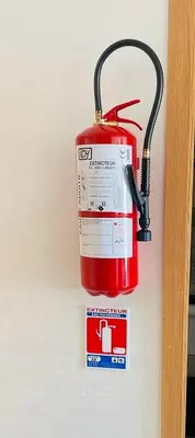 a fire extinguisher hanging on a wall at RA 14 Calme et Cosy Netflix, Wifi et parking gratuits in Marrakech