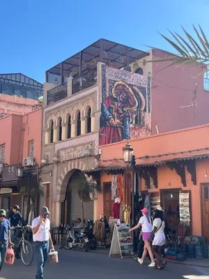 a group of people crossing a street in front of a building at Riad Le Saaliya in Marrakech