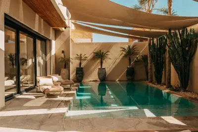 a swimming pool in the middle of a house at Villa Ayani in Marrakech
