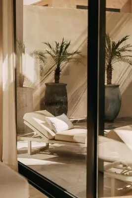 a window with a couch in a room with potted plants at Villa Ayani in Marrakech