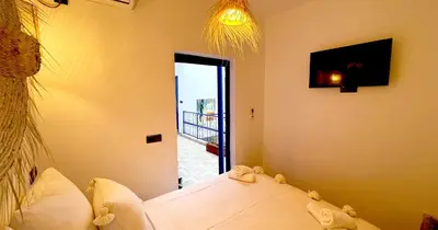 a room with a bed and a door to a balcony at Couloirs de la Médina in Marrakech