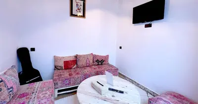 a living room with a couch and a table at Couloirs de la Médina in Marrakech
