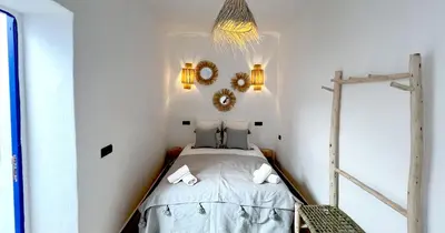 a small bedroom with a bed with two towels at Couloirs de la Médina in Marrakech