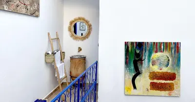a hallway with a painting hanging on a wall at Couloirs de la Médina in Marrakech