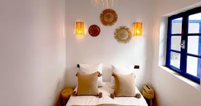 a bedroom with two beds with pillows and a window at Couloirs de la Médina in Marrakech
