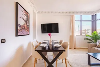 a dining room with a table and chairs in a living room at New, Appartement Miramas à Gueliz,en plein centre ville in Marrakech