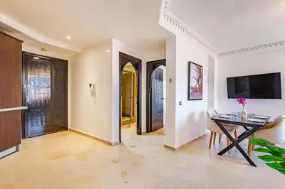 a living room with a table and a television at New, Appartement Miramas à Gueliz,en plein centre ville in Marrakech