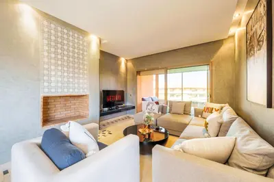 a living room with white furniture and a fireplace at Relax Front Of Golf-Atlas in Marrakech
