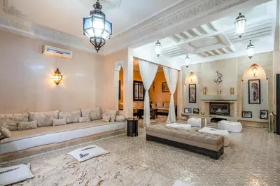 a large living room with couches and a fireplace at Villa Zeitoune - 8 pers - Piscine - Marrakech in Marrakech