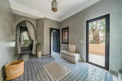 a living room with a blue door and a window at Villa Zeitoune - 8 pers - Piscine - Marrakech in Marrakech