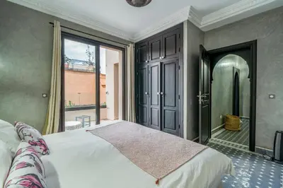 a bedroom with a bed and a large window at Villa Zeitoune - 8 pers - Piscine - Marrakech in Marrakech