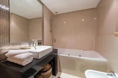a bathroom with a sink and a bath tub at Relax front of Golf-Pool-Topaze in Marrakech