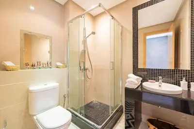 a bathroom with a shower and a toilet and a sink at Relax front of Golf-Pool-Topaze in Marrakech