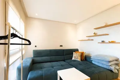 a living room with a blue couch and a table at PO 10 Appartement de luxe, golf, piscine & club house in Marrakech