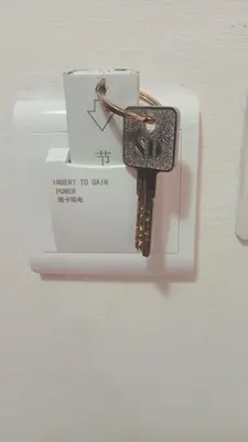 a key hooked up to a box on a wall at Riad marrakech boujloud in Marrakech
