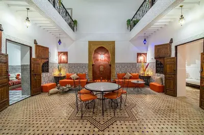 a lobby with a table and chairs and a room at Riad Khadoj-Marrakech-Traditional in Marrakech