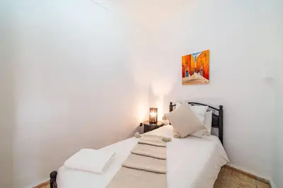 a bedroom with two beds with white sheets at Riad Khadoj-Marrakech-Traditional in Marrakech