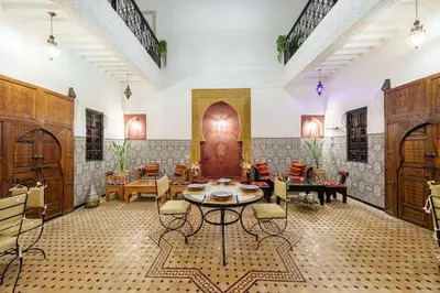 a large living room with a table and chairs at Riad Khadoj-Marrakech-Traditional in Marrakech