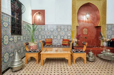 a living room with a table and chairs and a couch at Riad Khadoj-Marrakech-Traditional in Marrakech