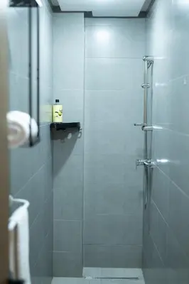 a shower with a glass door in a bathroom at Appartement pour famille ou couple à Marrakech in Marrakech