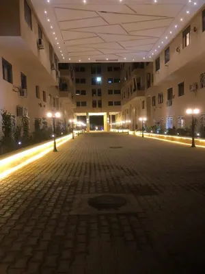 an empty courtyard of a building at night at Appartement pour famille ou couple à Marrakech in Marrakech