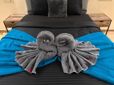 a pair of towels sitting on a bed at Appartement pour famille ou couple à Marrakech in Marrakech