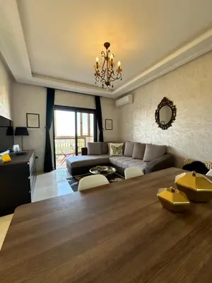 a living room with a couch and a table at Appartement Zazat in Marrakech