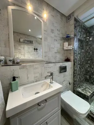 a bathroom with a sink and a toilet and a mirror at Appartement Zazat in Marrakech