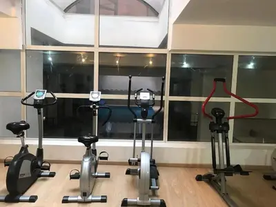 a group of exercise bikes in a room with a window at Gueliz Luxury Apt with Pool Self Check In 24 7 Security in Marrakech