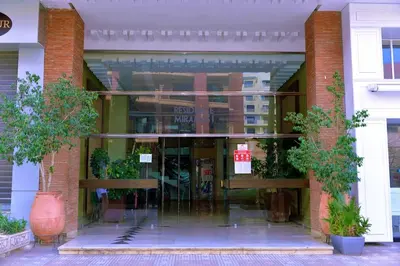 a glass entrance to a building with potted plants at Gueliz Luxury Apt with Pool Self Check In 24 7 Security in Marrakech