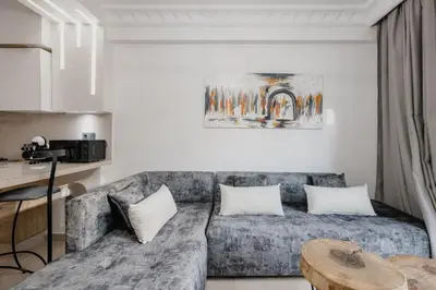 a living room with a couch and a table at Gueliz Luxury Apt with Pool Self Check In 24 7 Security in Marrakech