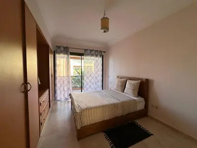 a bedroom with a large bed and a window at Résidence Dar Damana Palmeraie Marrakech in Marrakech